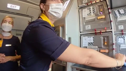 Split, Croatia - 06/13/2021: Flight attendant give face mask to passengers Stock Footage 275344091