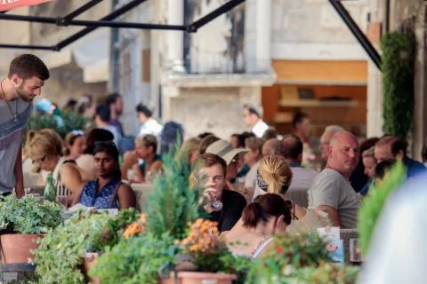 Split, Croatia - August 19, 2017: People sit and enjoy their meal in some str Stock Photos