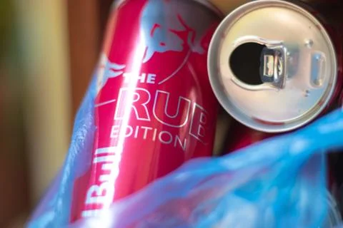 Split Croatia August 2020 Empty red bull red Ruby cans in trash, recycling us Stock Photos