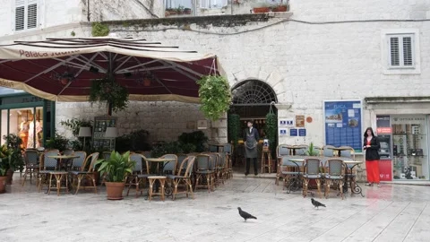 Split, Croatia- June 09 2022: Empty Restaurant in Morning, Waiter Looking Out Vídeos de archivo 203536894