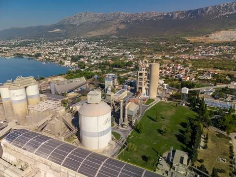 SPLIT, CROATIA - SEPTEMBER 9, 2026 CEMEX factory stands beside coastal town,  Stock Photos