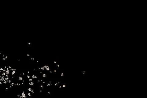Split debris of stone exploding against black background. Stock Photos