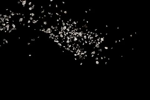 Split debris of stone exploding against black background. Stock Photos