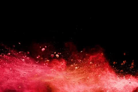 Split debris of  stone exploding with orange powder splash against black. Stock Photos