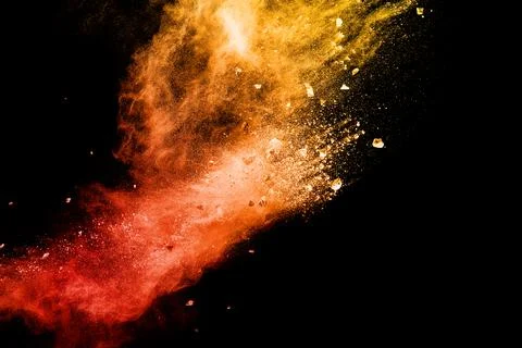 Split debris of  stone exploding with orange red powder splash. Stock Photos