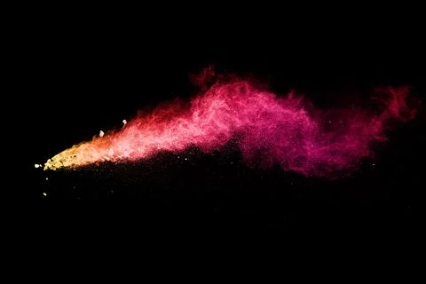 Split debris of stone exploding with red dust against black background. Stock Photos