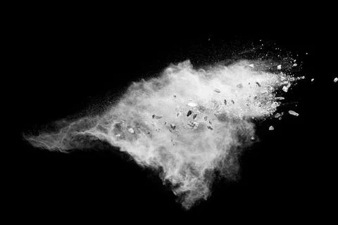 Split debris of  stone exploding with white powder against black background. Stock Photos
