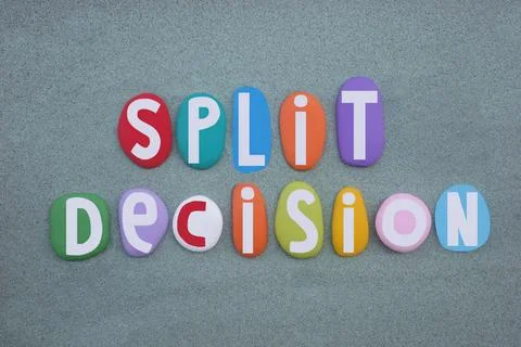 Split Decision, creative text composed with colored stone letters Stock Photos