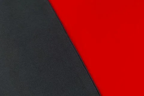 A split diagonal layout of two contrasting smooth cotton fabrics, with dark.. Stock Photos