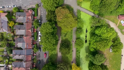 Split drone view of Victorian houses and Lloyd Park, Walthamstow London contrast Stock Footage 336413945
