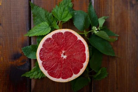 Split grapefruit on a brown wooden background, top view, text space, citrus Stock-Fotos