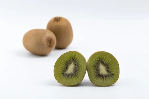 Split green kiwi on white background Stock Photos