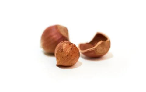 Split hazelnut, kernel and shell isolated on white background Foto stock