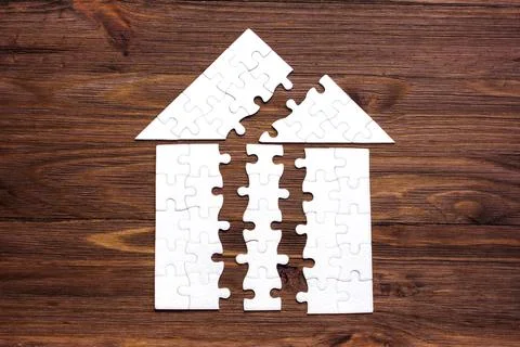 Split House Shape Made from Jigsaw Puzzle Elements Foto stock