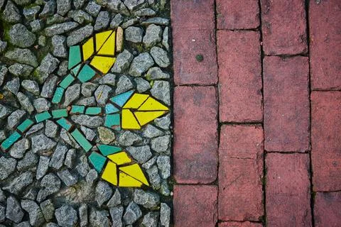 Split image, red bricks beside gravel stones with abstract mosaic of flowers Fotos Stock