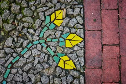 Split image, red bricks next to gravel stones with abstract mosaic of flowers Stock-Fotos