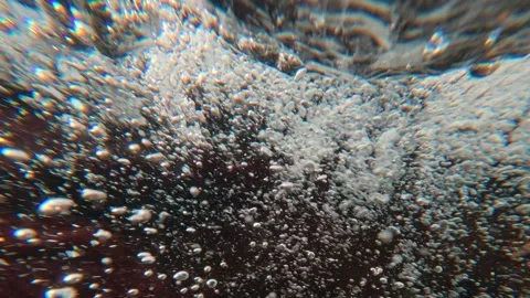 Split level, camera slowly descends underwater into stormy stream of mountain Stock Footage 341279749