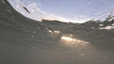 Split level ocean footage shows waves above and below water with air bubble.. 스톡 동영상 342587125