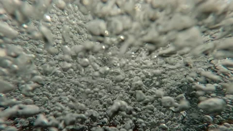 Split level underwater shot of camera descending into an endless flow of air Stock Footage 333593968