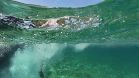 Split level view of a boy jumping into the sea water with splash 스톡 동영상 338182313