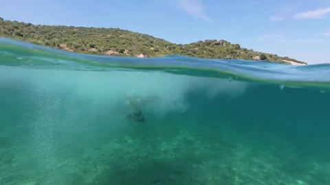 Split level view of a boy jumping into the sea water with splash 스톡 동영상 338182329
