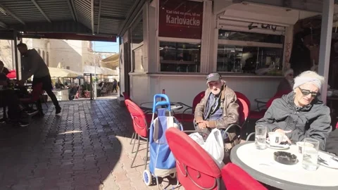 Split Market Coffee Corner with Elderly Women Talking and Man in Background Stock Footage 332121934