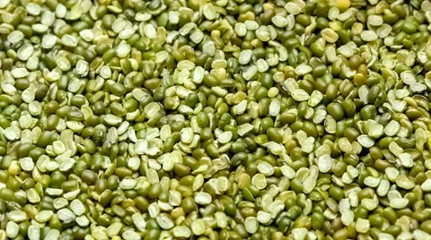 Split mung been legumes scooping up and falling from wooden spoon, slow motio Stock Footage 67194836