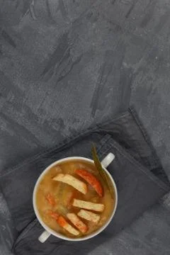 Split pea soup in white plate with handles top view with copy space. Fotos de archivo