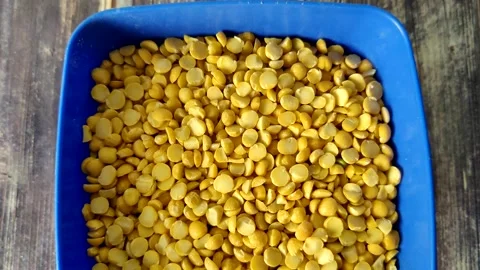 Split peas close-up in a blue bowl on a wooden table Stock Footage 230015020
