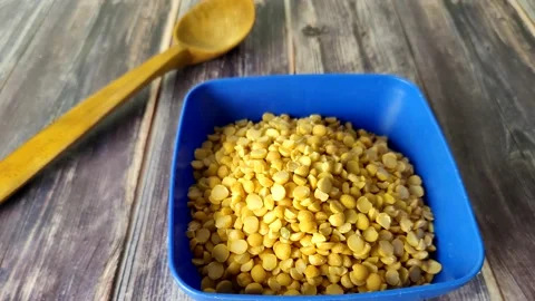 Split peas close-up in a blue bowl on a wooden table Stock Footage 230015022