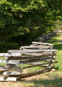 Split rail fence by edge of forest Traditional split rail fence by side of... Stock Photos