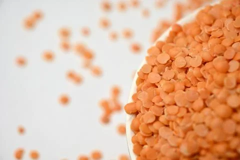 Split Red Lentils (Masoor Dal) Top View with Negative Space on White Defocu.. Foto stock