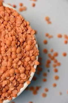 Split Red Lentils (Masoor Dal) Top View with Negative Space on White Defocu.. Stock Photos