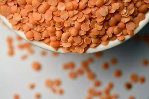 Split Red Lentils (Masoor Dal) Top View with Negative Space on White Defocu.. Stock Photos