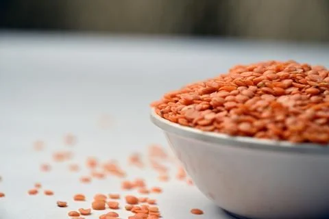Split Red Lentils (Masoor Dal) Front View with Negative Space on White Defo.. Stock Photos