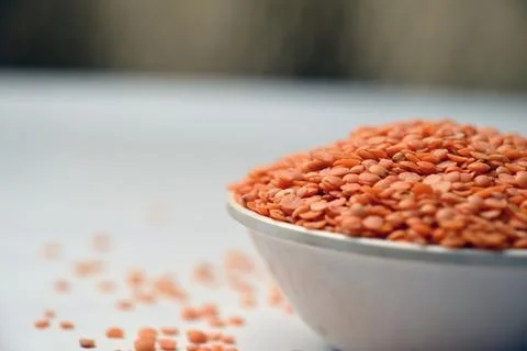 Split Red Lentils (Masoor Dal) Front View with Negative Space on White Defo.. Stock Photos