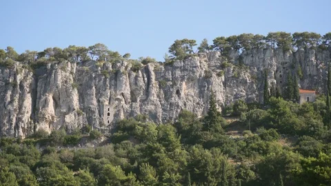 Split Rock Adriatic sea  Coast line with cyclists on road long shot in Croati Stock Footage 111742355