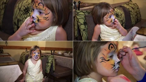 Split screen. The little girl painted her face in gouache. Face art picture o Stock Footage 176857841