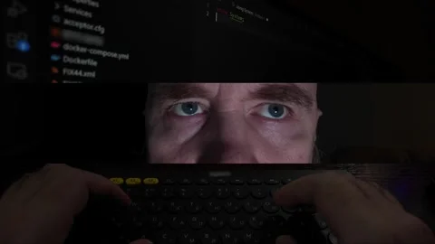 Split-screen of programmer: coding, eyes, and typing hands. Dark theme Stock Footage 301668219