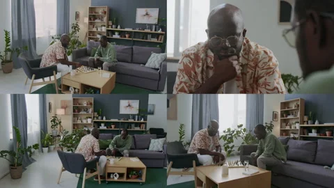 Split Screen of Two Black Men Playing Chess at Coffee Table in Living Room Stock Footage 291629334