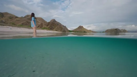 Split shot at the beach in the Komodo National Park with woman Vídeo Stock 331162321