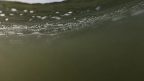 Split shot POV of someone struggling to keep head above water in ocean Video stock 340296928
