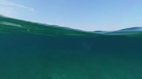 Split shot of sea water over under half underwater view of clear ocean 스톡 동영상 338181765