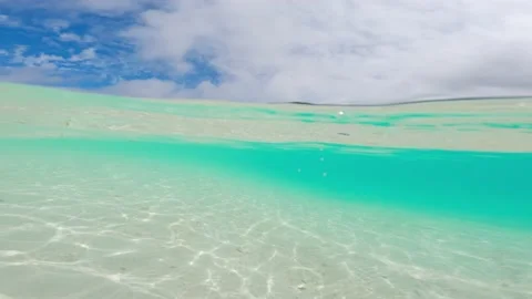 Split shot of tropical ocean with a boat, camera half above half below water of Stock Footage 234100020