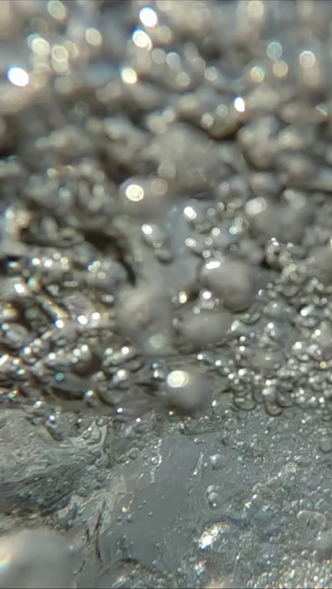 Split shot of turbulent waterfall stream splashing on water surface, creating Vidéo 338024979