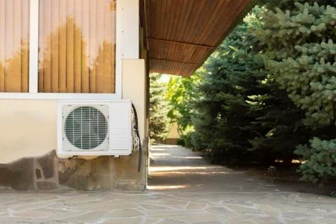 A split system air conditioner unit outdoors with air cleaning equipment Stock Photos