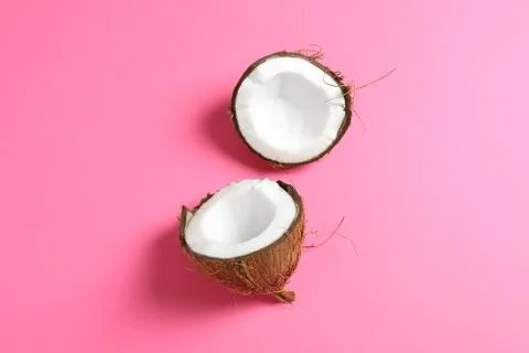 Split tropical coconut on color background, space for text Stock Photos