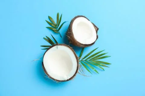 Split tropical coconut on color background, space for text Stock Photos