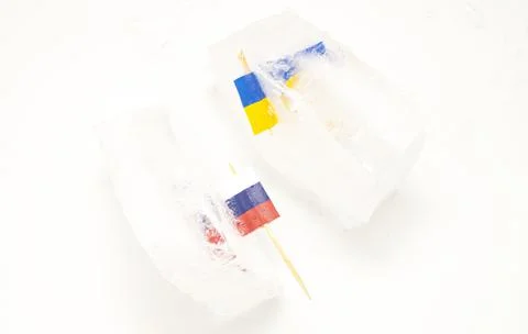 The split of two friendly countries. Two flags frozen in ice flags of Russia  Stock Photos