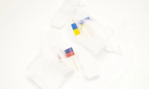 The split of two friendly countries. Two flags frozen in ice flags of Russia  Stock Photos